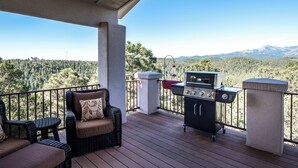 An outdoor deck with wicker furniture and a grill. - Alto Grand View by Ruidoso Vacation Rentals (Alto)