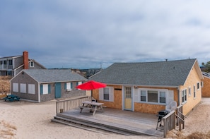 Relax on the elevated deck with a view of the beach and surrounding area.