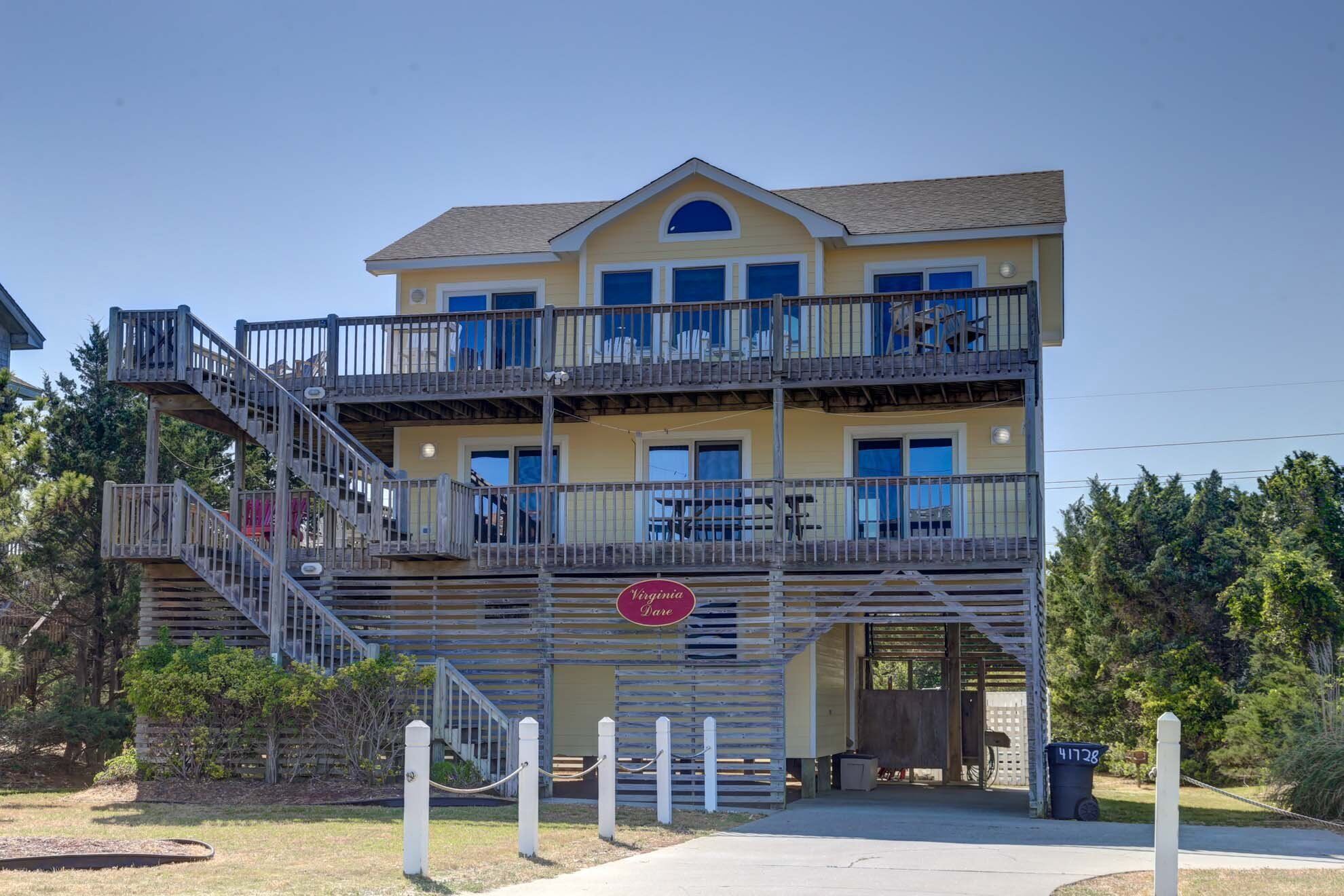A multi-story building with a balcony on the second floor, a sign reading "Virginia Dale," and a wooden staircase leading to the entrance.
