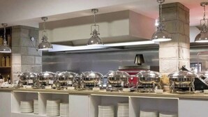 A buffet setup with multiple serving stations, each equipped with a food container and a stack of plates. - Apartment Sleeps 4 with Pools Access - Smart TVs (Sunny beach)
