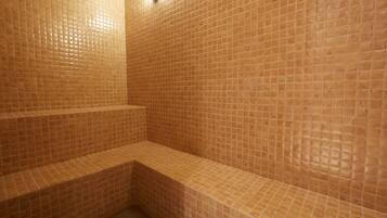 Step into a serene bathroom with a bench for relaxation and a convenient seating area.