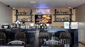 A bar area with a sign reading "LIONAW POOL BAR" and a menu board advertising "BELMONT HOTEL MACATAN".