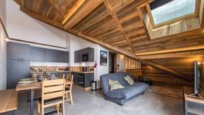 A modern loft-style living space with a kitchen, dining area, and seating area.