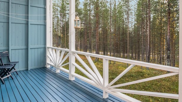 A covered porch with a view of a forest. - Isokurunpuisto a 2 by Interhome (Pelkosenniemi)