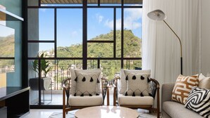 A modern living room with a large window, two sofas, a coffee table, and a floor lamp. - 2BD 2Bath Oceanview The Palm on the Tree Unit 10  2BD Condo for rent in Old Town (Puerto Vallarta)