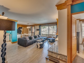 A spacious living area with a sofa, a coffee table, and a dining table.