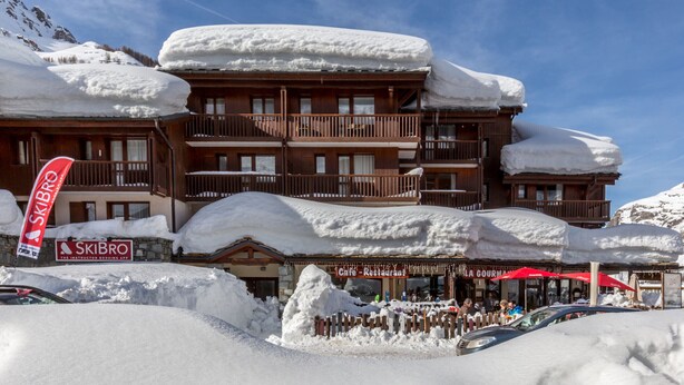 A wooden building with balconies and a sign for 'SKIBRO'. - **Cozy Ski-In/Ski-Out Apartment Near Children's Village, Sleeps 5** (Val-d'Isère)