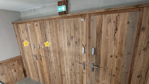 A row of wooden wardrobe doors with star stickers and a small exit sign above them. - Modern Studio with Balcony, Ski-In/Ski-Out, and Free WiFi in Val-d'Isère (Val-d'Isère)