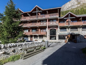 A multi-story wooden building with balconies, stone walls, and a sign for 'Les Chalets de Sotaise'. - Charming, Fully Renovated Apartment with High-Quality Amenities, Ideal Location in Val-d'Isère (Val-d'Isère)