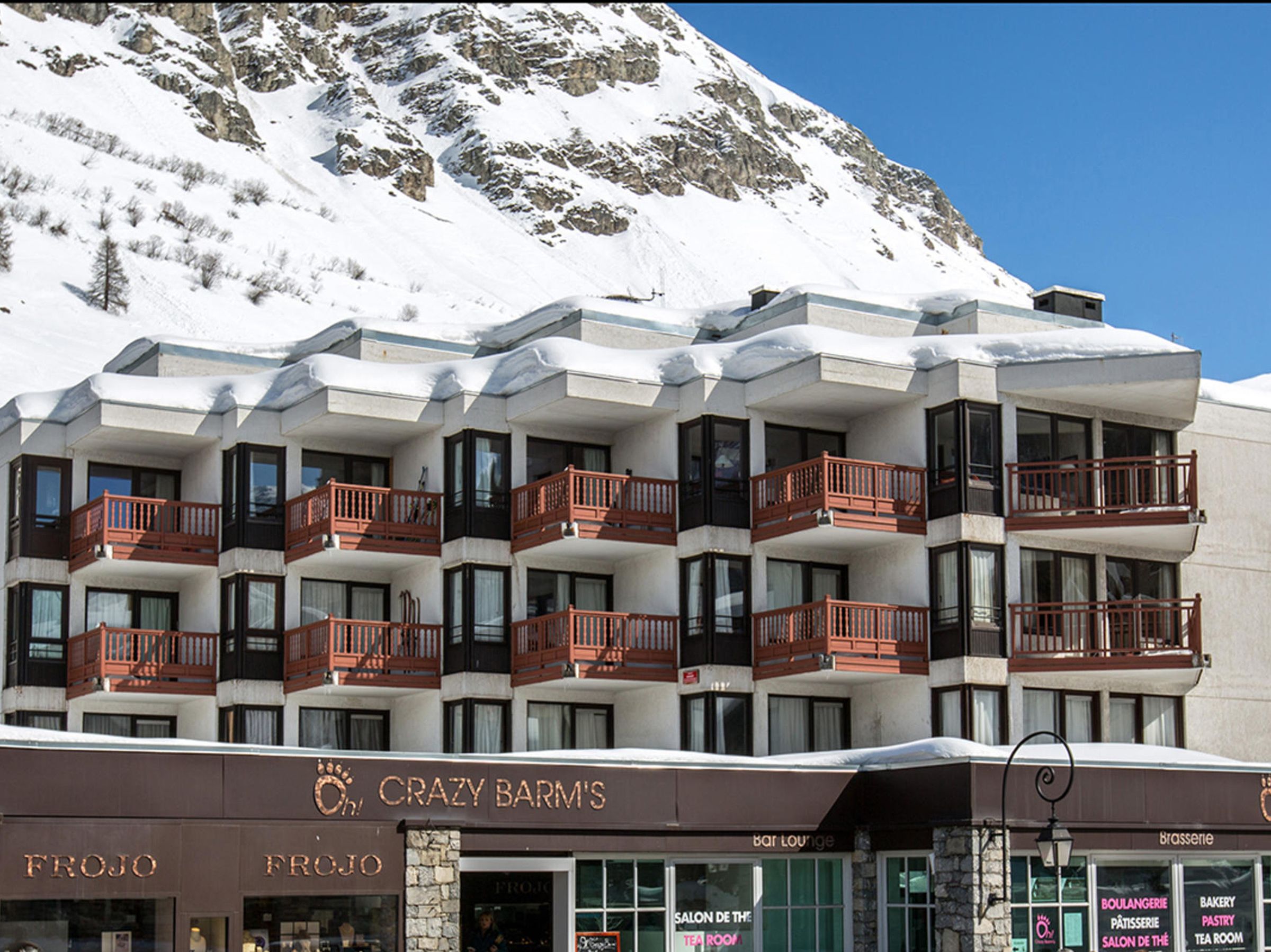 A multi-story hotel with balconies, a bar lounge, and a tea room.
