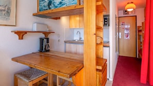 A compact kitchen with wooden cabinets, a coffee machine, and a sink. - Cozy ski-in studio, 3 ppl, La Daille, Val-d'Isère (Val-d'Isère)