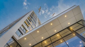 A modern building with large windows and a flat roof.