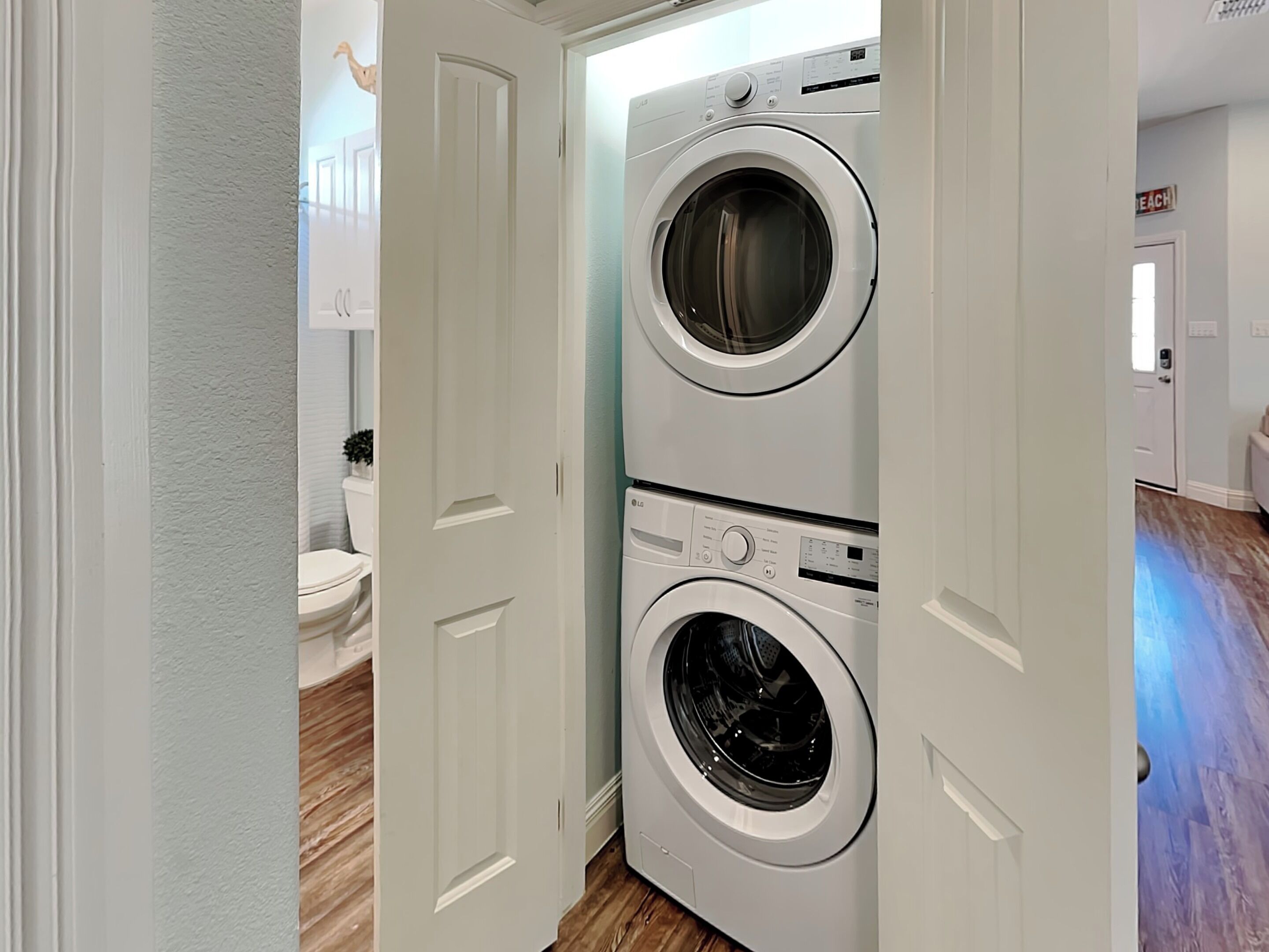 A laundry room with two stacked front-loading washing machines.