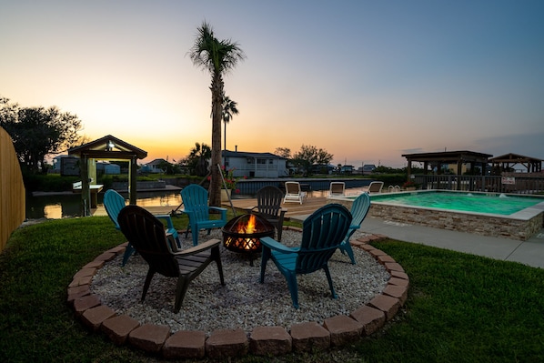 Relax and socialize in a serene outdoor setting with a patio, fire pit, and swimming pool.