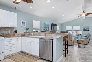 Enjoy cooking in this well-equipped kitchen with a central island, dishwasher, and dining area.