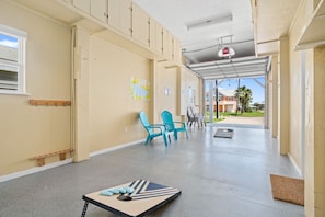 Stroll through this serene corridor, lined with comfortable seating and a stylish table, leading to a view of the surrounding landscape.