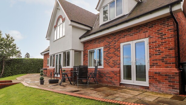 A two-story house with a brick exterior and a tiled roof. - Hafan Fach (Mold)