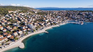An aerial view of a coastal town with densely packed buildings, a marina, and a beach. - Villa Moreta with heated pool, Sauna, Hot-tub (Okrug Gornji)