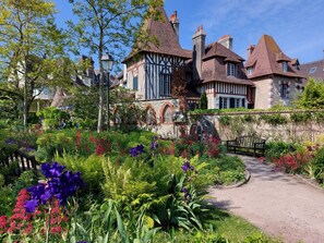 A historic building with a garden path leading to the entrance.