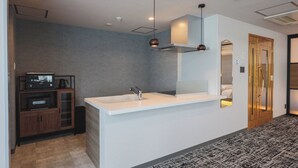 A modern kitchen with a white countertop, a built-in stove, and pendant lighting. - Gran Palette Hakodate (Hakodate)