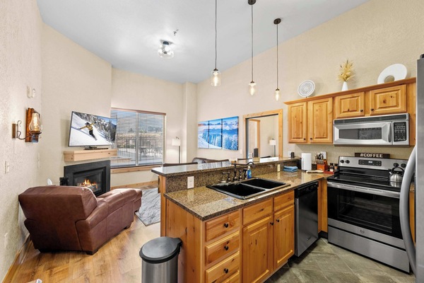 Main living space: Open layout, well equipped kitchen, living room, couch w/ full Queen super sleeper flip-out bed, 48” Smart TV, electric fireplace