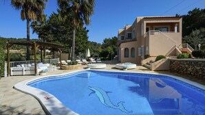 A swimming pool with a dolphin design, lounge chairs, and a pergola. - VILLA CAS PUIG Two houses in 1 !!!!  with 2 full kitchen, air conditioned in all the rooms! (Sant Joan de Labritja / San Juan)