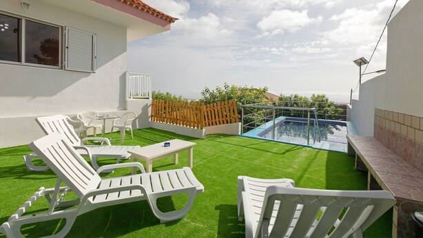 A rooftop with artificial grass, white lounge chairs, a small table, and a pool. - Clemente House, Private Pool – Sea Views, Private Terrace, and Wi-Fi (arafo)