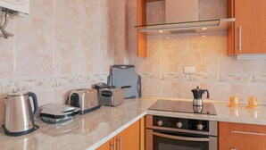 A modern kitchen with a built-in oven, a coffee maker, and a toaster. - Clemente House, Private Pool – Sea Views, Private Terrace, and Wi-Fi (arafo)