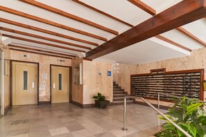 A lobby with marble flooring, wooden beams, a staircase, and a wall with a filing system. - Holiday Apartment "Amador" with Sea View, Pool & Garden (Algarrobo-Costa)