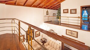 A multi-level interior with wooden beams, a staircase, and a chandelier. - Vacation Home "La Victoria' with Sea View, Private Terrace & Wi-Fi (La Victoria)