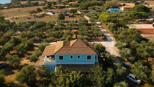 A coastal property with a prominent house, a swimming pool, and surrounding vegetation. - Studio Apartment "Areti Orfeas Studio" near Beach with Balcony & Wi-Fi (Zakynthos)