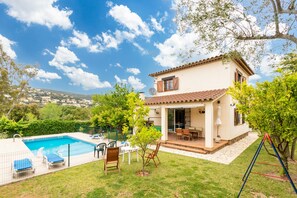 A house with a swimming pool, outdoor seating, and a view of the surrounding landscape. - Villa "Pelach" with Pool & Wi-Fi (Calonge)