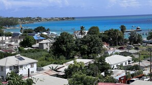 A coastal residential area with houses, solar panels, and a view of the ocean. - 3 Bedrooms in paradise w/fruit trees 3 mins-Oistins! (Oistins)