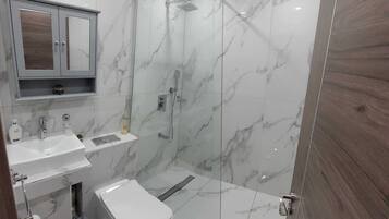 Shower, rainfall showerhead, hair dryer, towels