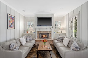 Smart TV, fireplace, books, computer monitors