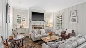 Smart TV, fireplace, books, computer monitors