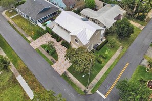 A residential area with houses, a driveway, and a street. - Incredible 7BR | Game Room Heated Pool and Jacuzzi (Deerfield Beach)