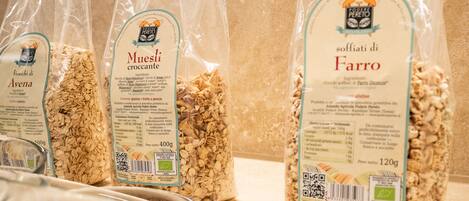 Three bags of Muesli crocanti on a kitchen counter.