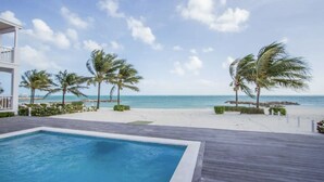 A pool area with a view of the beach and ocean. - Modern Luxury Townhome in Nassau - steps to the beach! (Nassau)