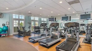 A gym with treadmills, elliptical machines, and weight equipment. - ⭐️Gorgeous Sunset Island Private Beach In/Outdoor Pools⭐️ (Ocean City)