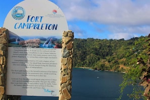 A sign for Fort Campbleton with a view of the surrounding landscape. - CHOLSON CHALETS LIMITED (Charlotteville)