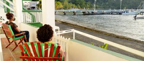 Enjoy breathtaking views of the water and surrounding landscape from this balcony.