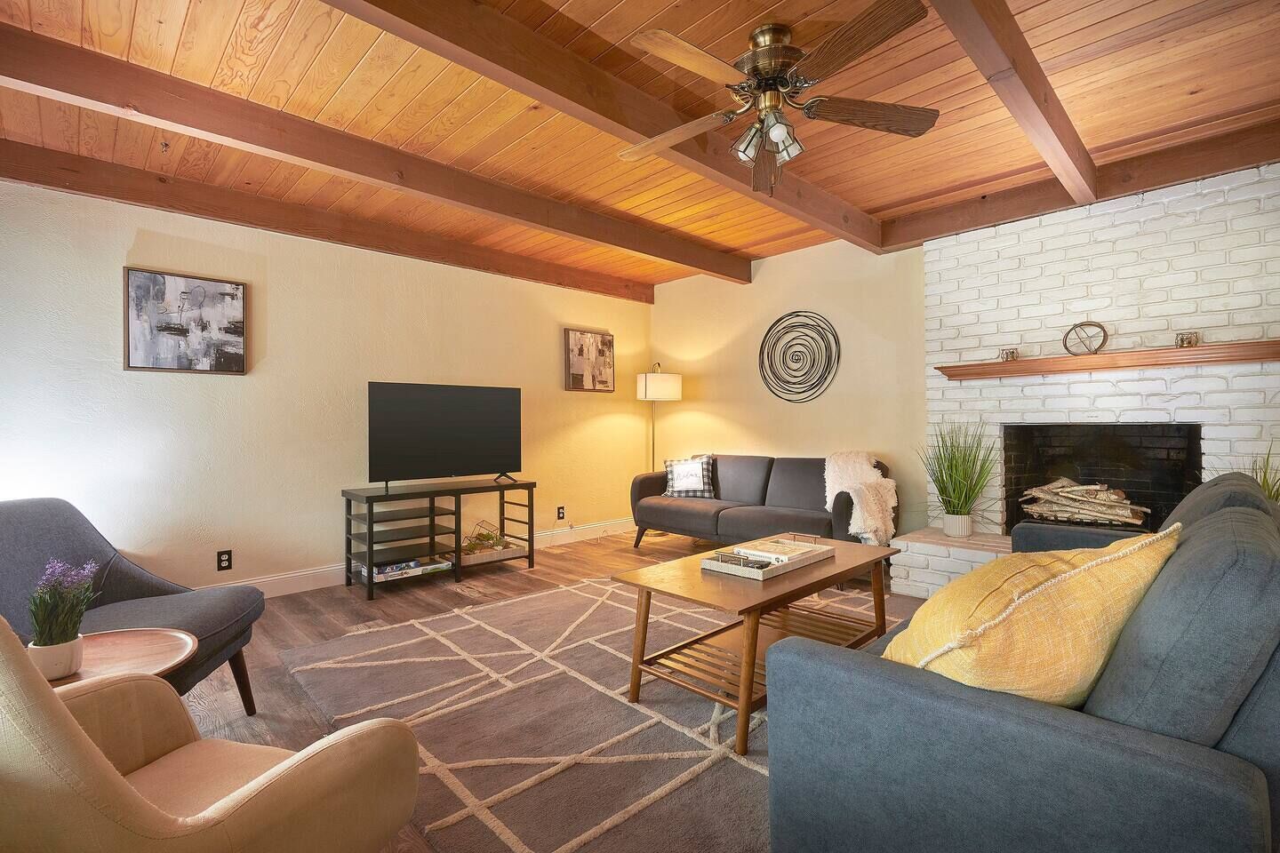 A cozy living room with a fireplace, a television, and comfortable seating.