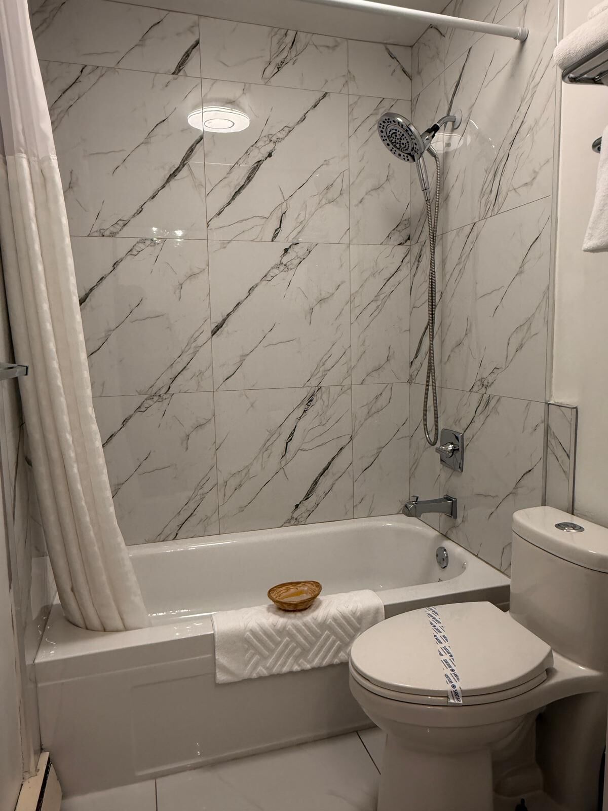 Combined shower/bathtub, hair dryer, towels, soap