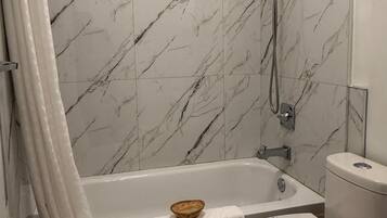 Combined shower/bathtub, hair dryer, towels, soap