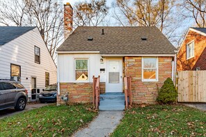 A two-story house with a brick facade, a front door, and a small front yard with a pathway leading to the entrance. - 5mins Drive to Detroit Zoo 3 bedrooms 2 full bath (Detroit)