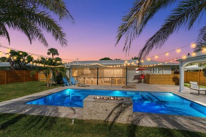 Clean Florida Coastal Design home with Heated Pool, Fireplace and Putt Putt