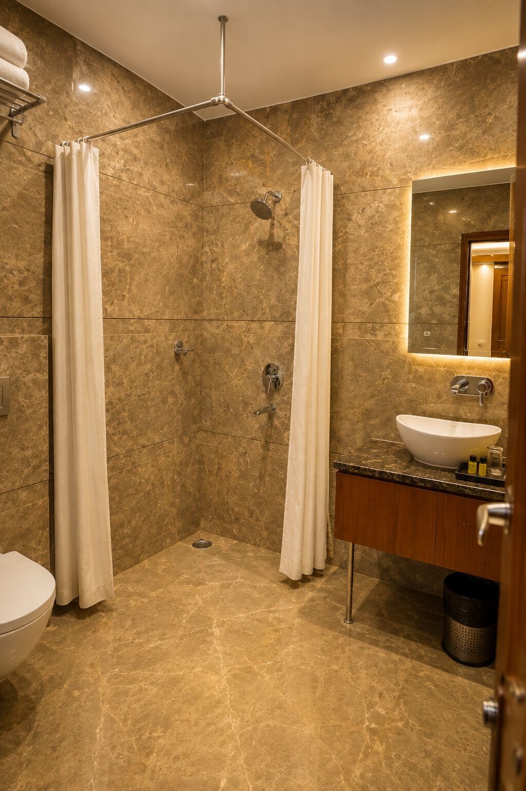 Un bagno moderno con doccia a pavimento, un water e un lavandino con specchio.