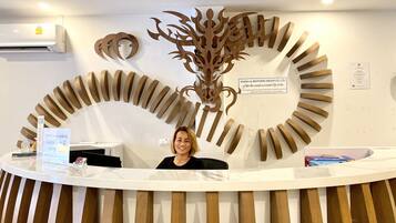 A reception desk with a decorative wooden panel and a sign for SHEIKH & BROTHERS GROUP CO., LTD.
