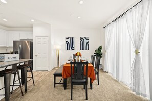 A modern kitchen with white cabinets and a stainless steel refrigerator. - New Townhouse/3BD/2.5BA (Chino)